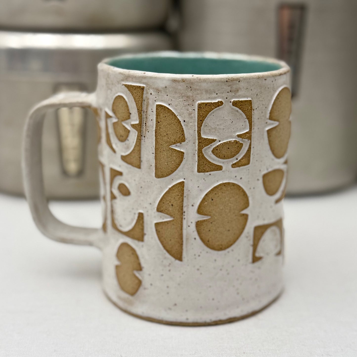 Ceramic mug with pattern on a white surface