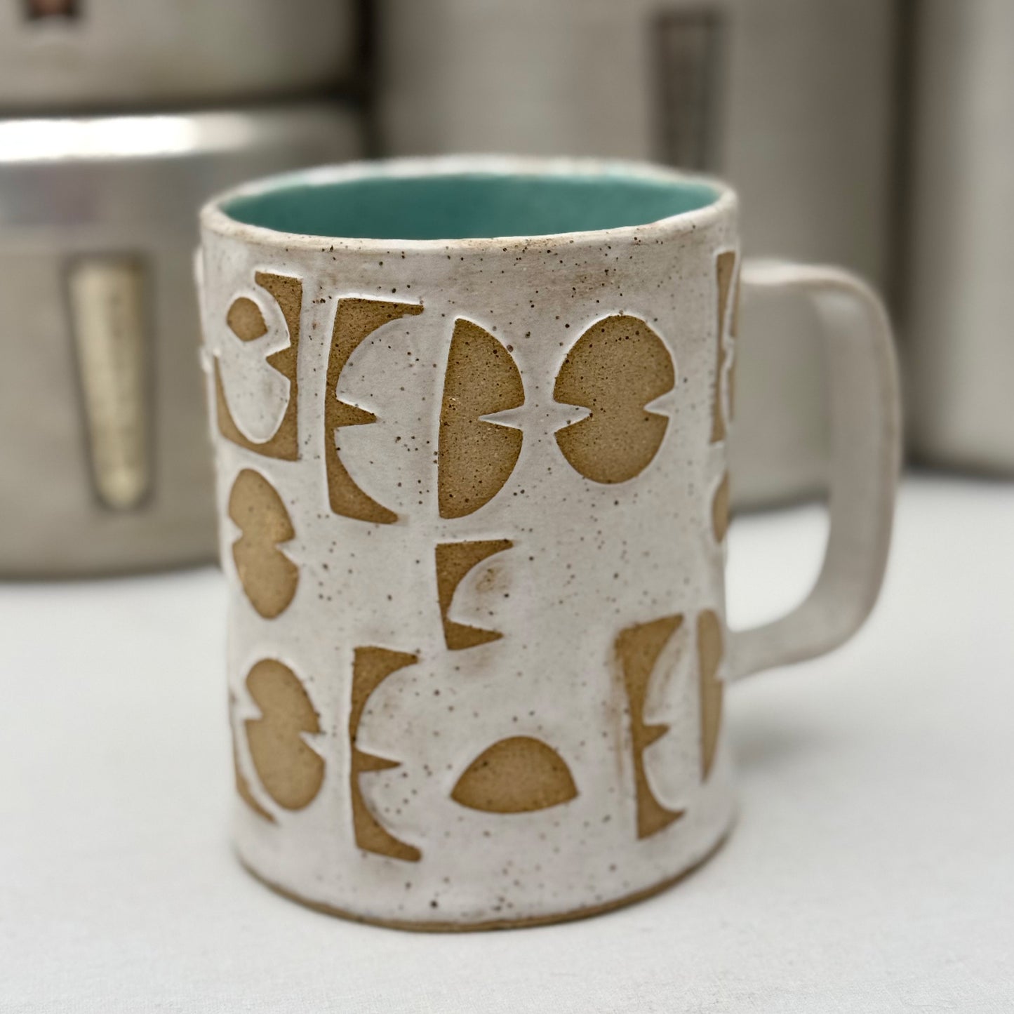 Ceramic mug with pattern on a white surface