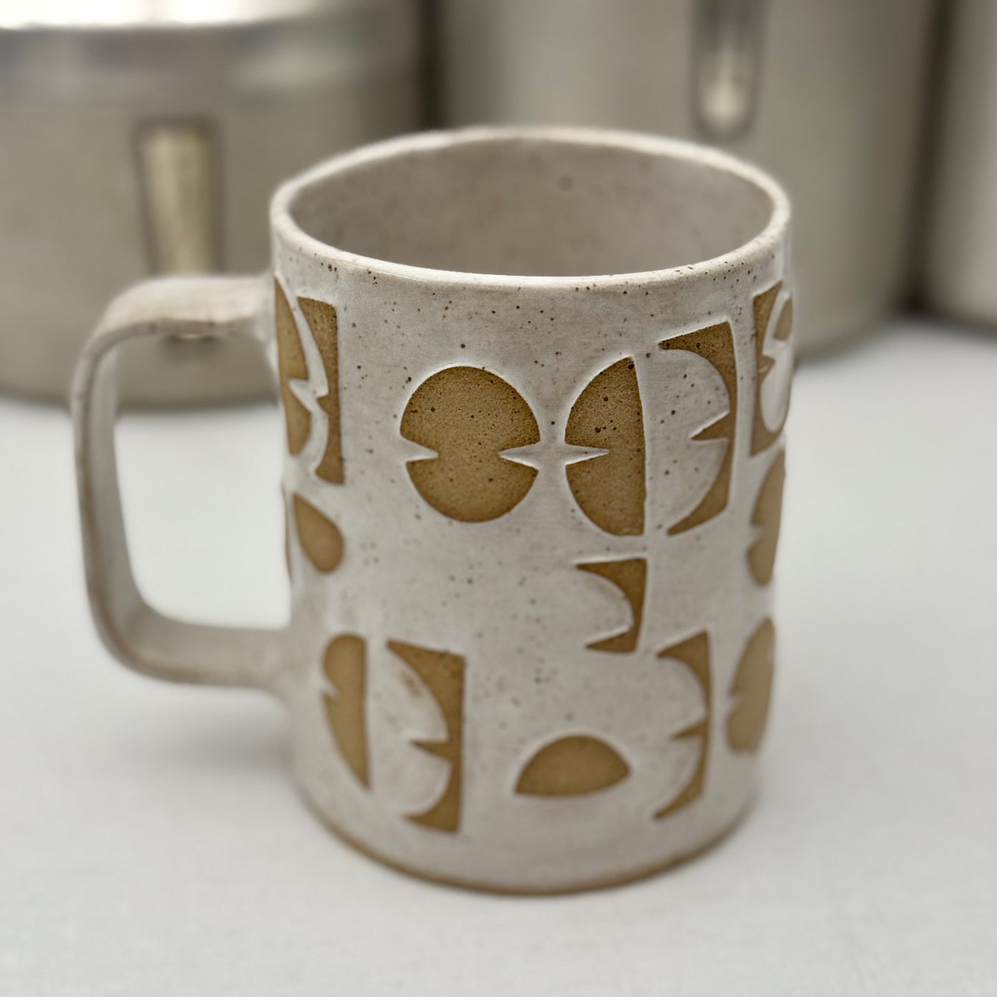 Ceramic mug with geometric design on a white surface