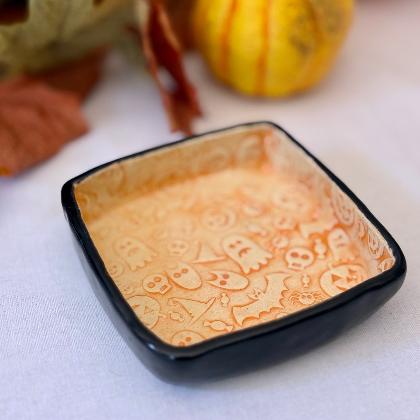 Decorative trinket dish with Halloween-themed design on a light background.
