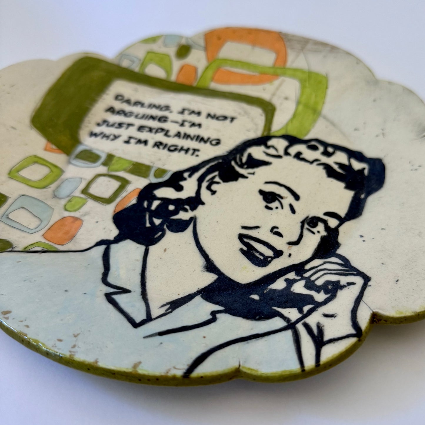 Decorative plate with a vintage-style illustration of a woman and text on a white background