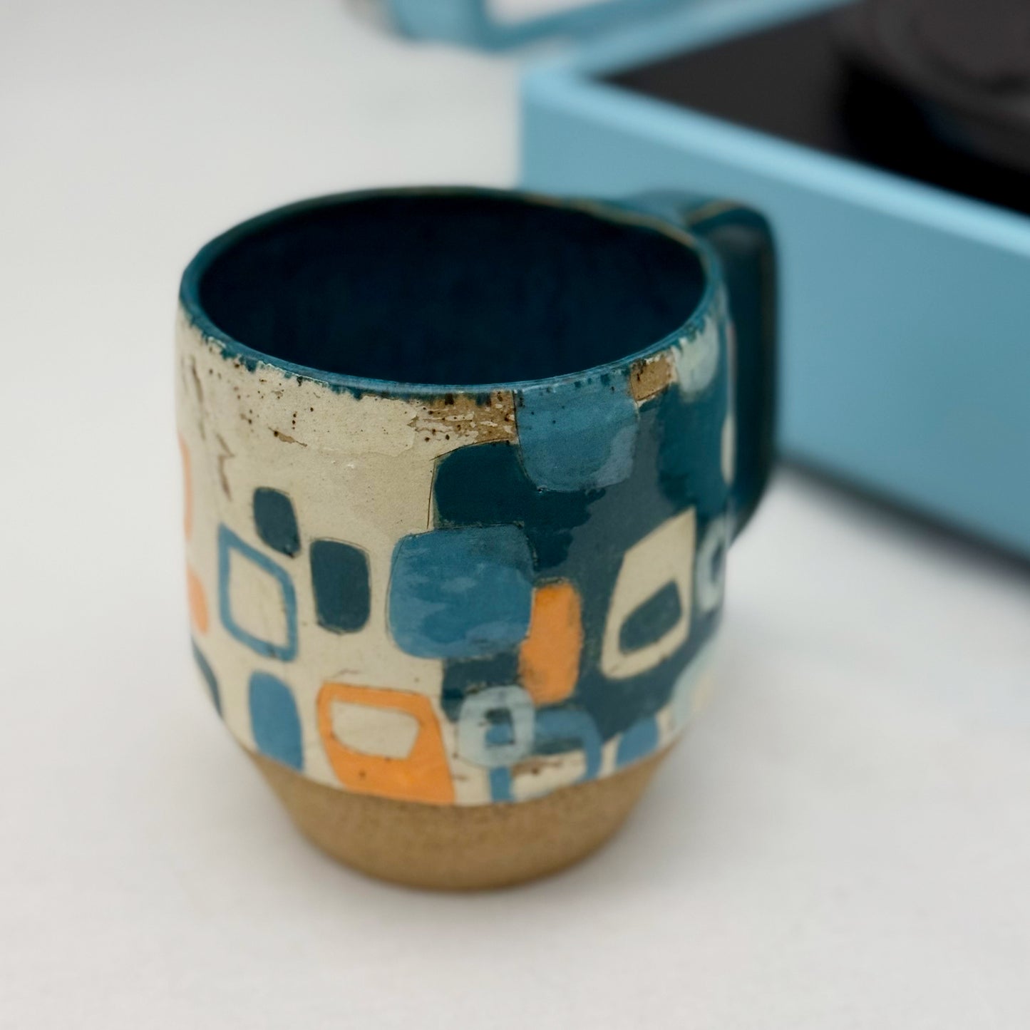 Ceramic mug with geometric pattern on a white surface