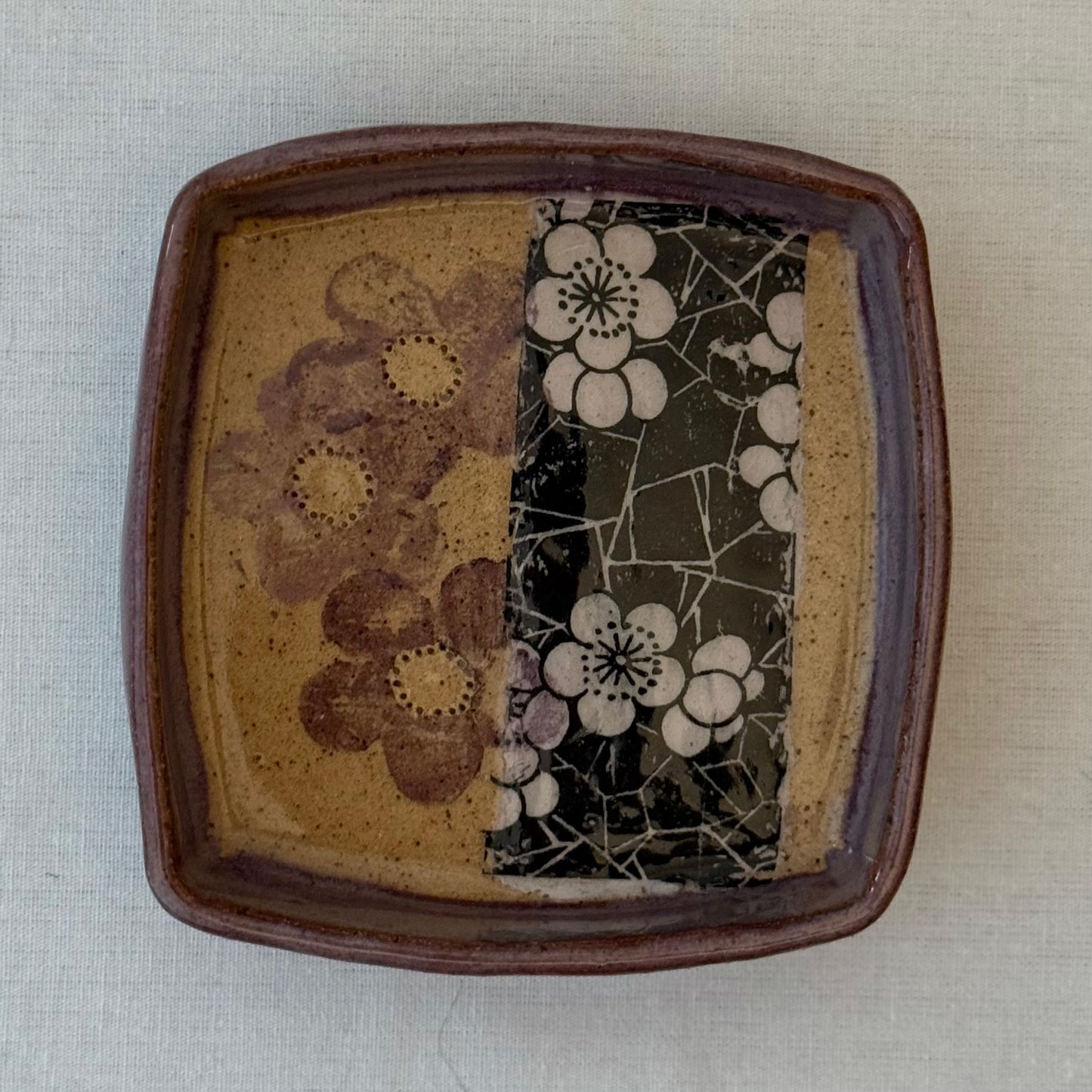 Ceramic tray with floral patterns on a white surface