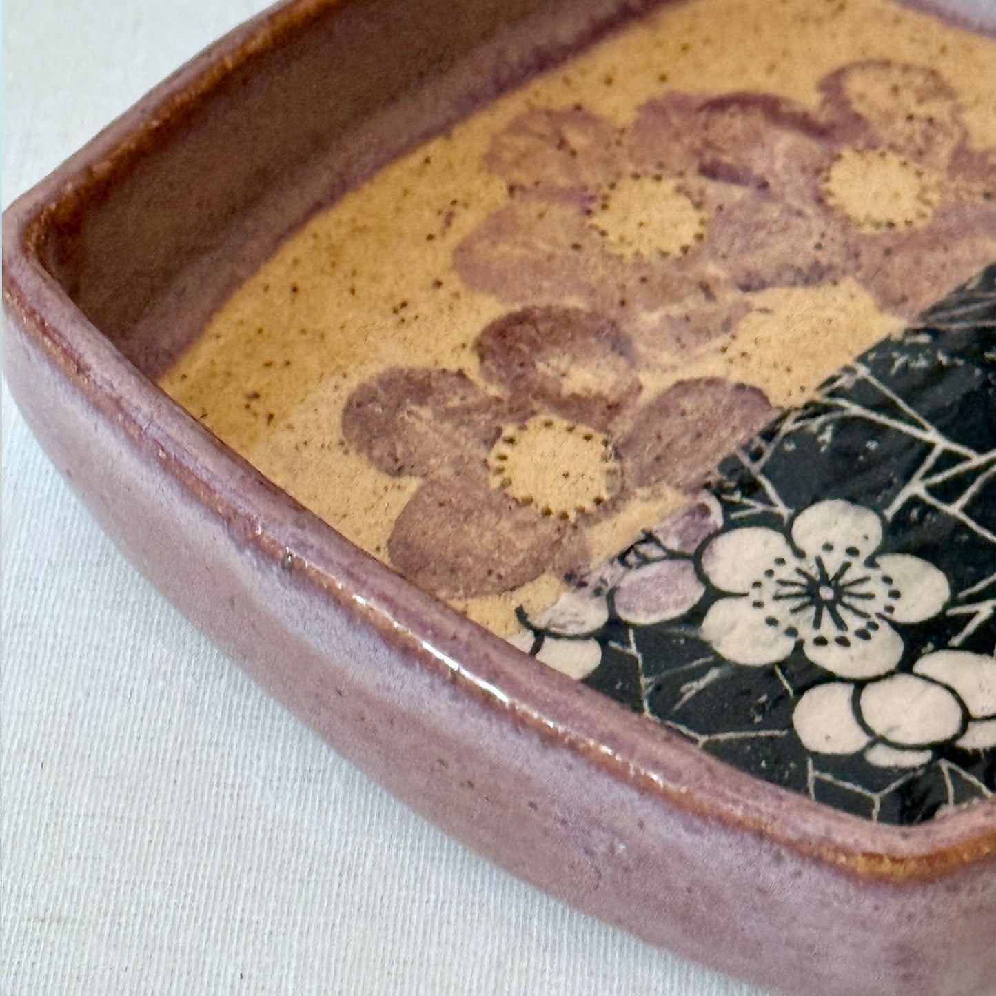 Ceramic tray with floral patterns on a white surface
