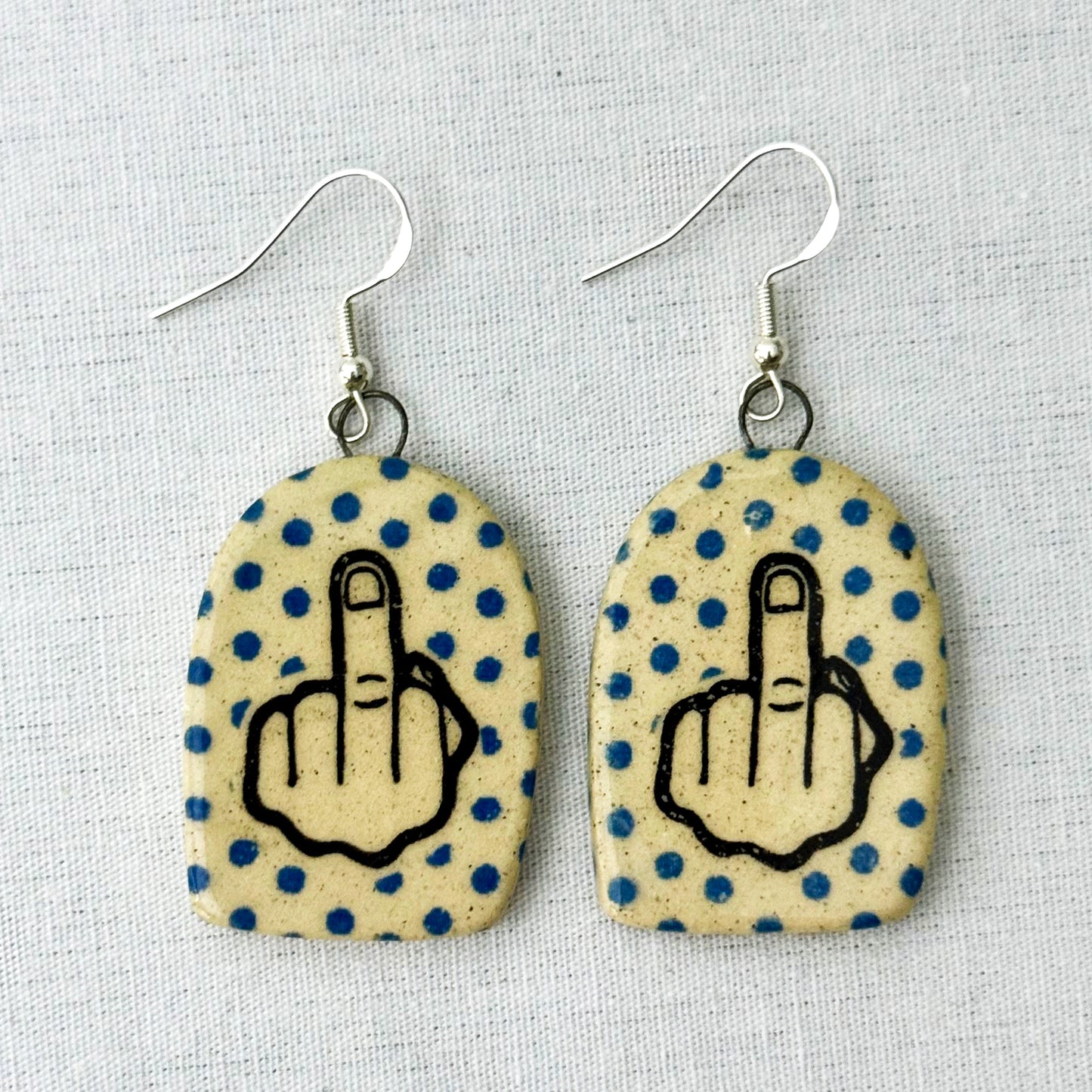 Earrings with polka dot pattern and middle finger design
