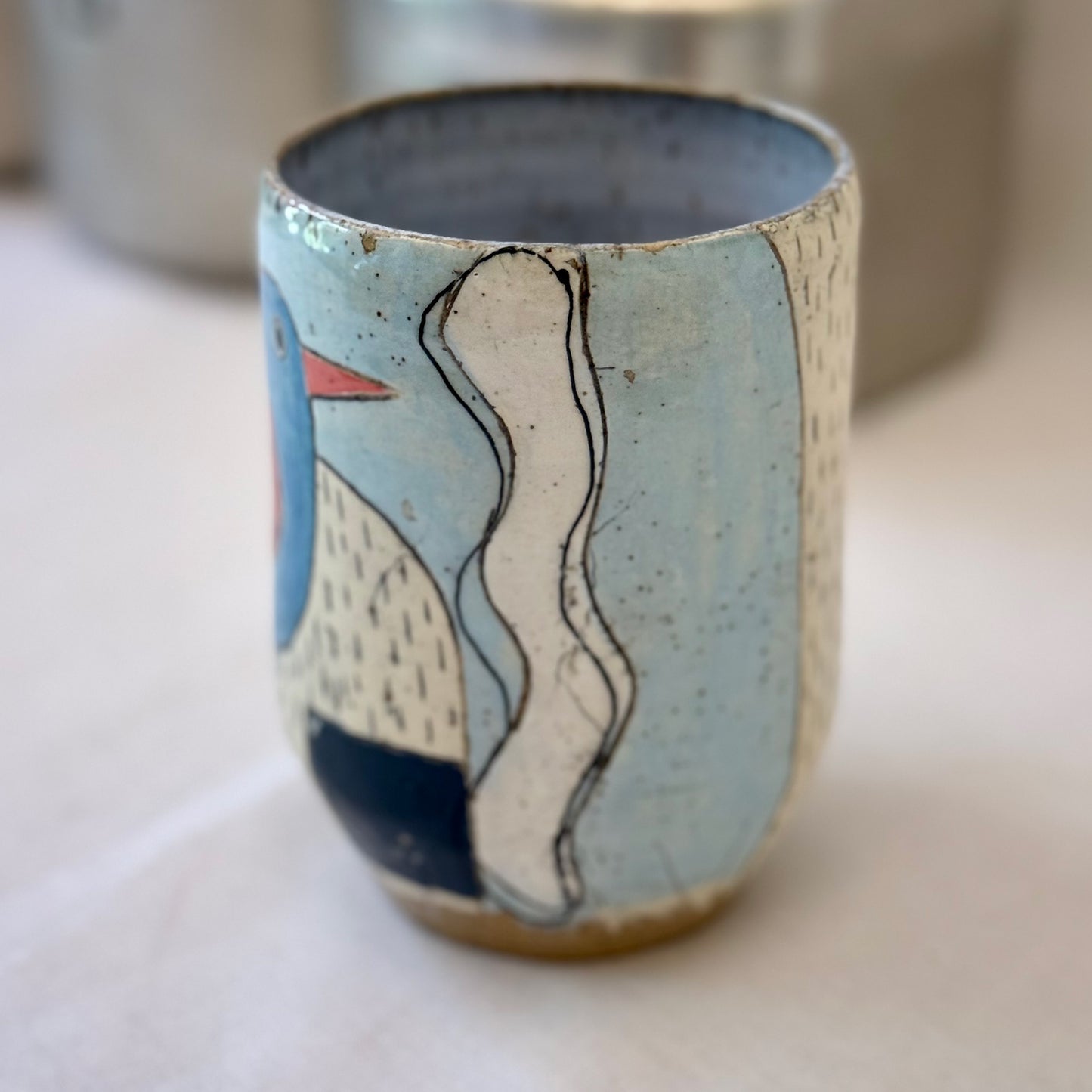 Ceramic cup with abstract design on a light surface