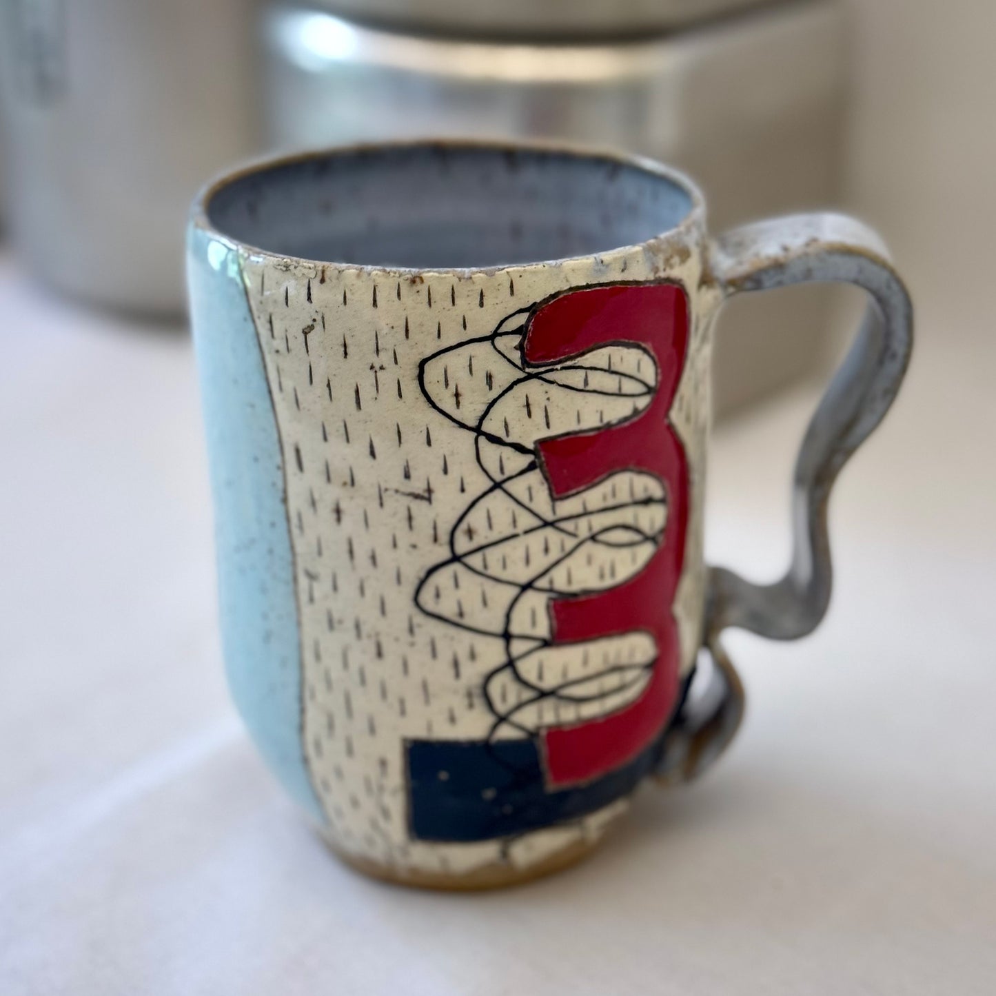 Ceramic mug with abstract design on a white surface