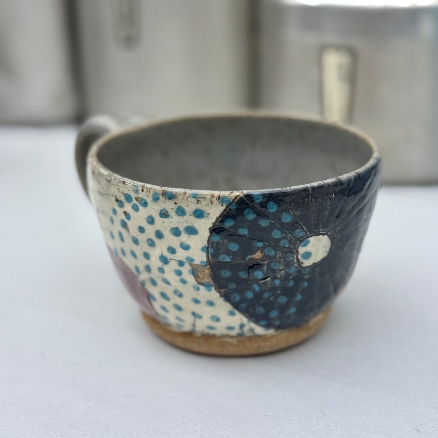 Ceramic cup with textured design on a white surface