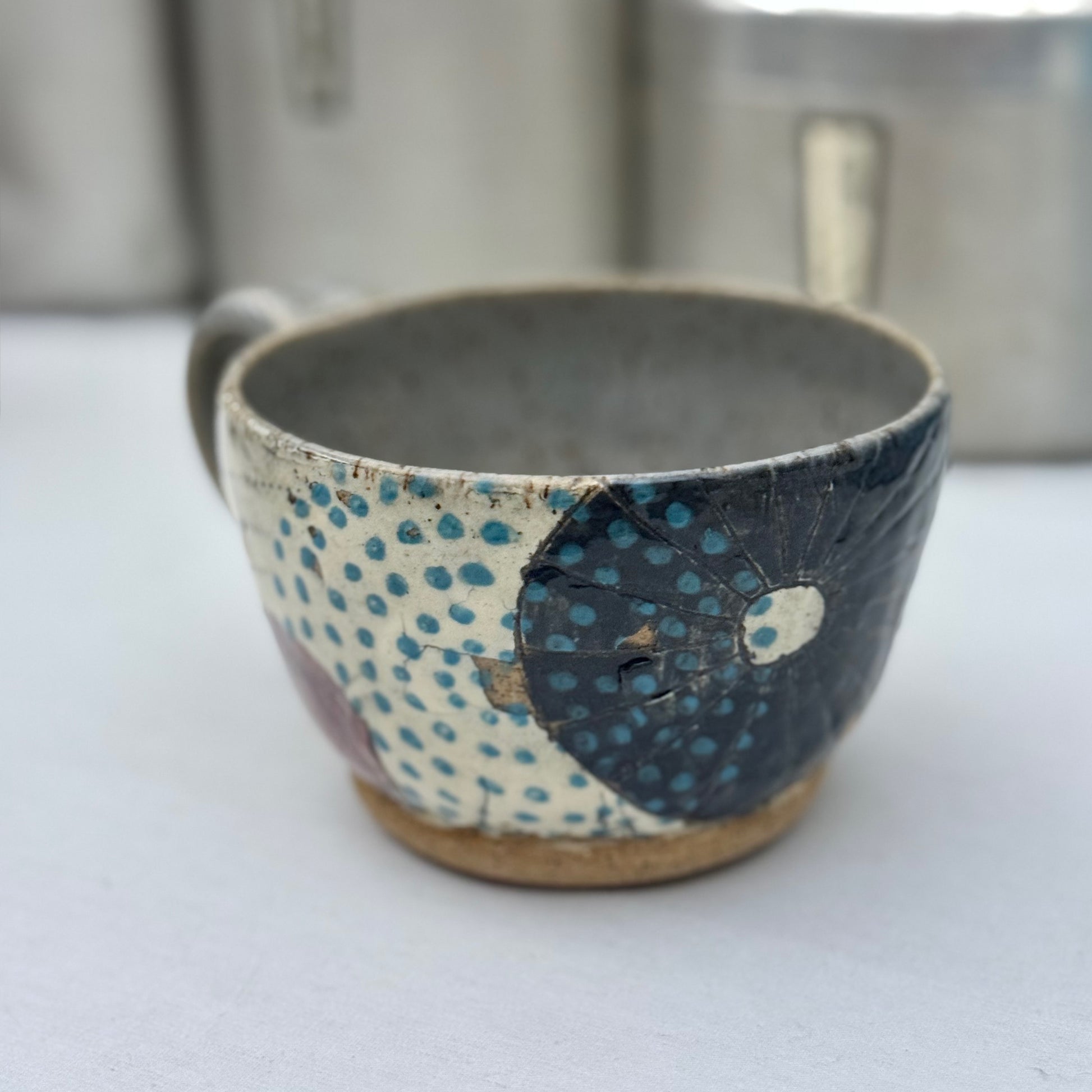 Ceramic cup with textured design on a white surface