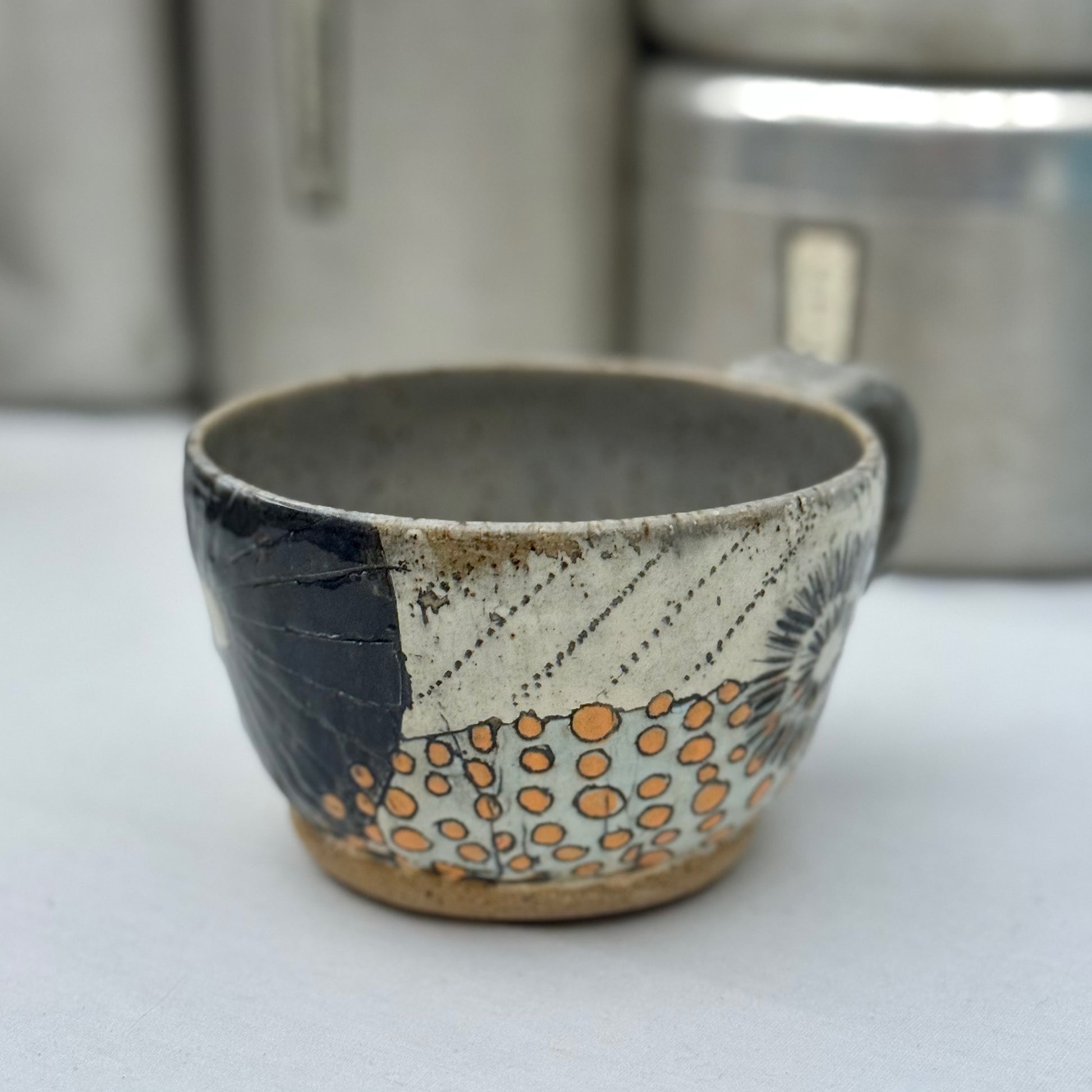 Ceramic cup with decorative patterns on a white surface