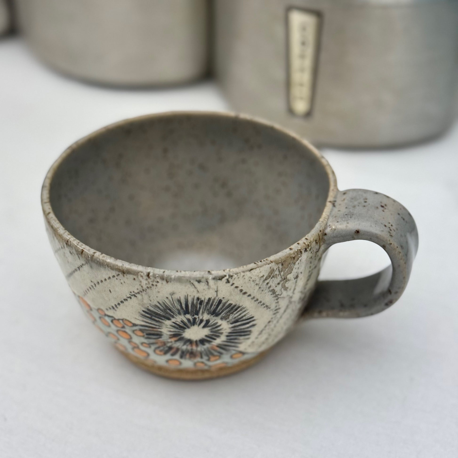 Ceramic mug with decorative patterns on a white surface