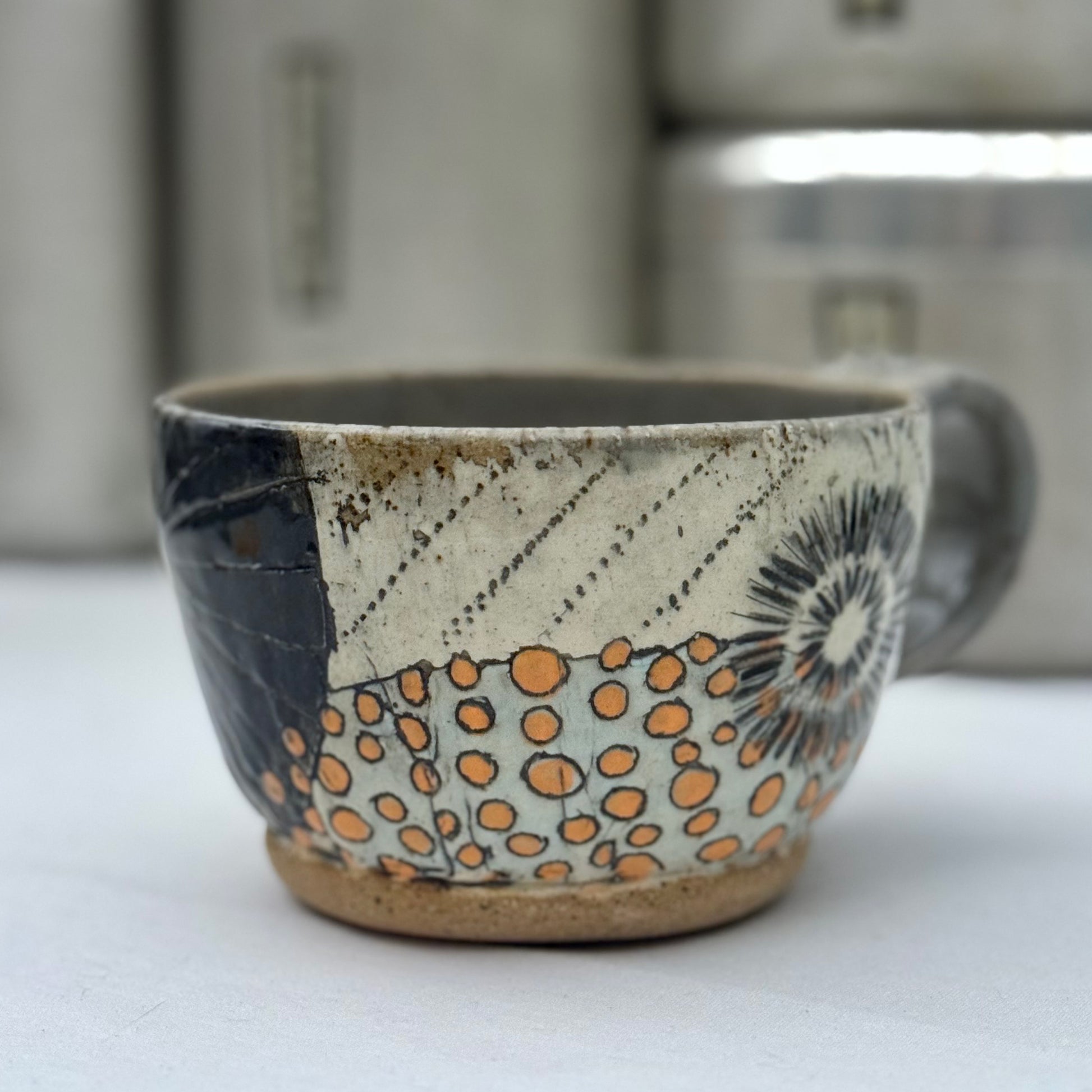 Ceramic cup with decorative patterns on a white surface