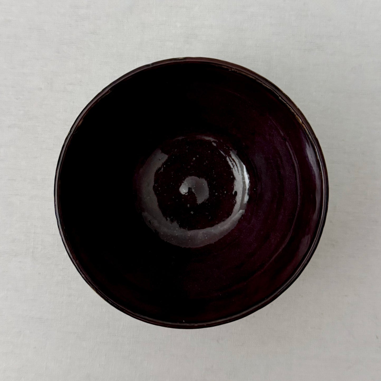 Purple ceramic bowl on a white background