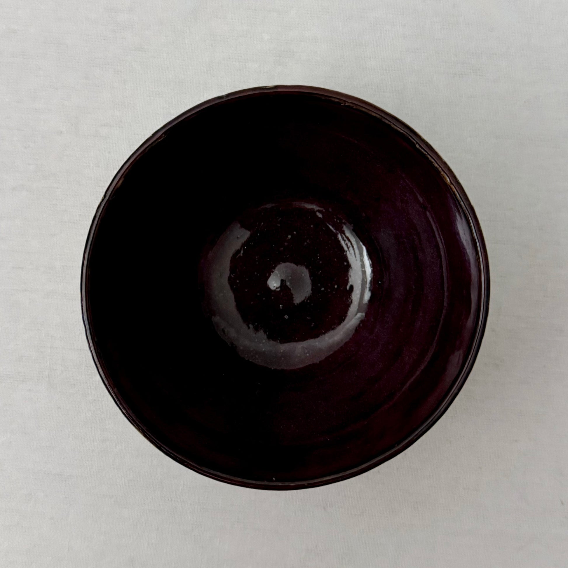 Purple ceramic bowl on a white background