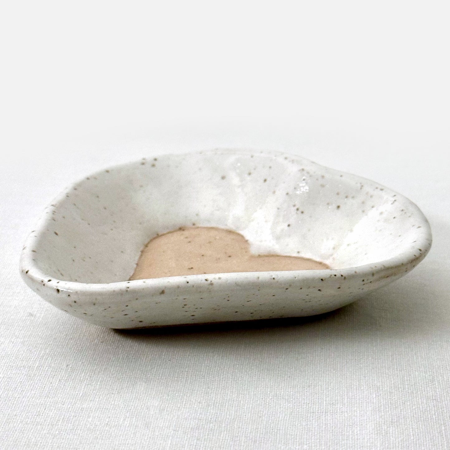 Speckled ceramic dish on a white background