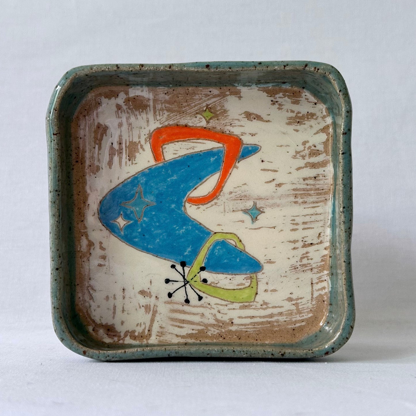 Ceramic tray with mid century design on a white background