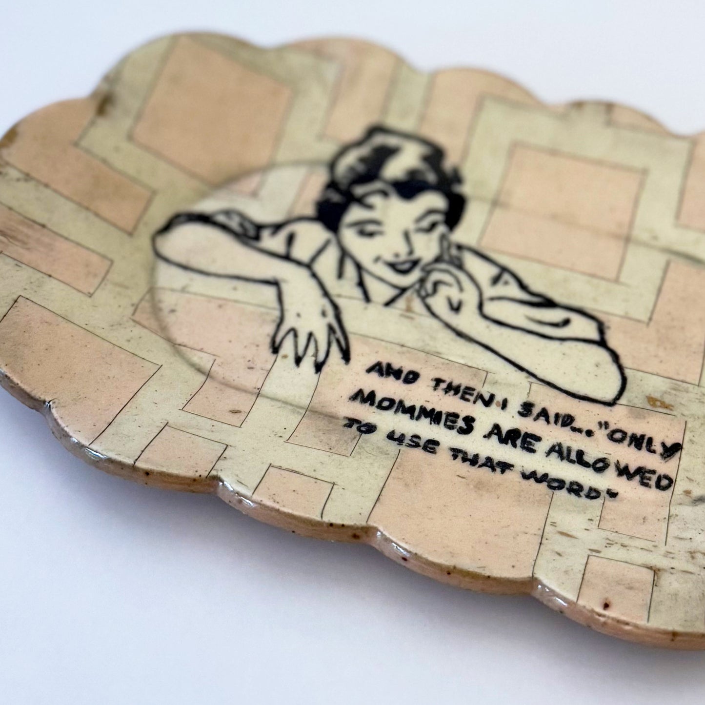 Decorative plate with a vintage-style illustration of a woman and text on a white background