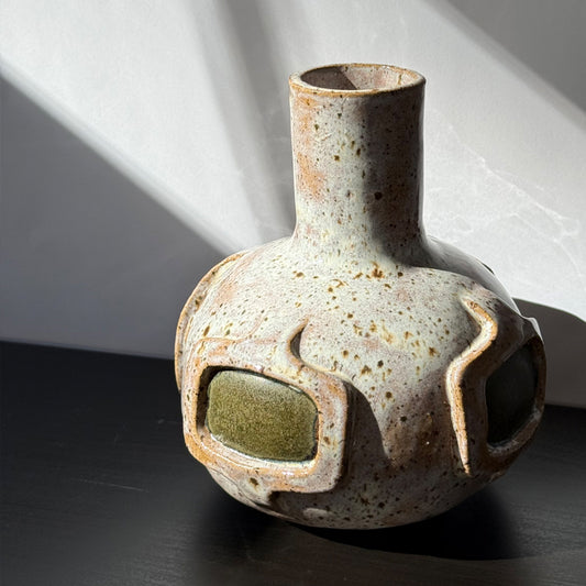 Handmade ceramic vase featuring a mid-century modern geometric pattern with olive green accents and a warm speckled ivory glaze.