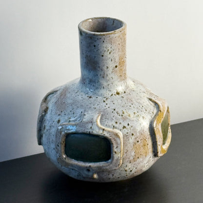 Handmade ceramic vase featuring a mid-century modern geometric pattern with olive green accents and a warm speckled ivory glaze.
