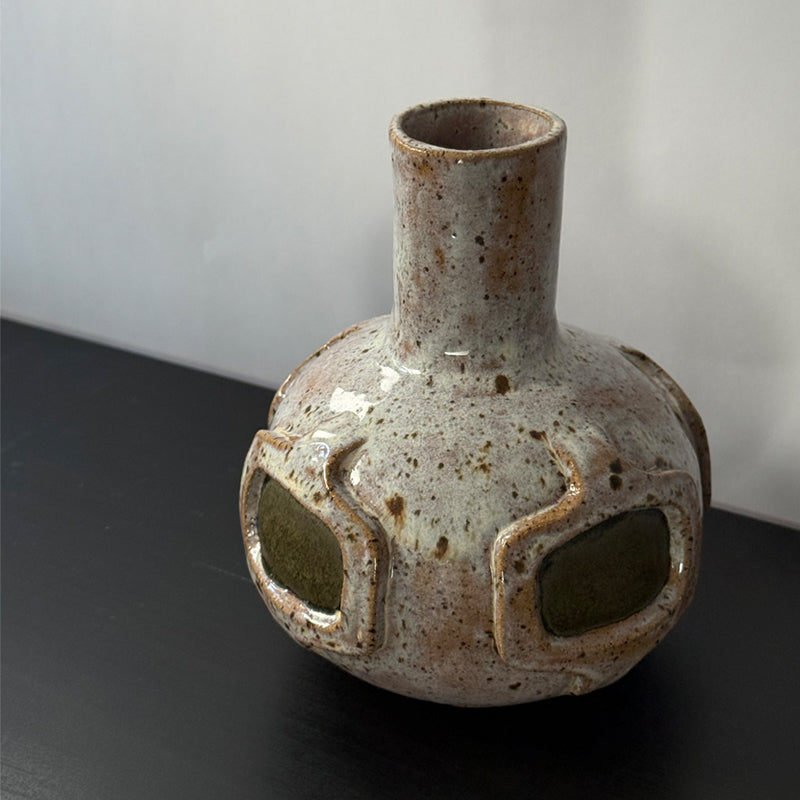 Handmade ceramic vase featuring a mid-century modern geometric pattern with olive green accents and a warm speckled ivory glaze.