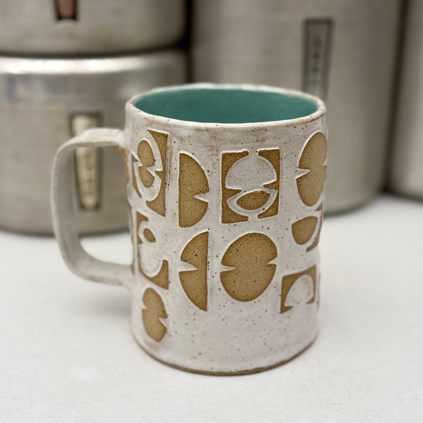 Ceramic mug with geometric pattern on a white surface