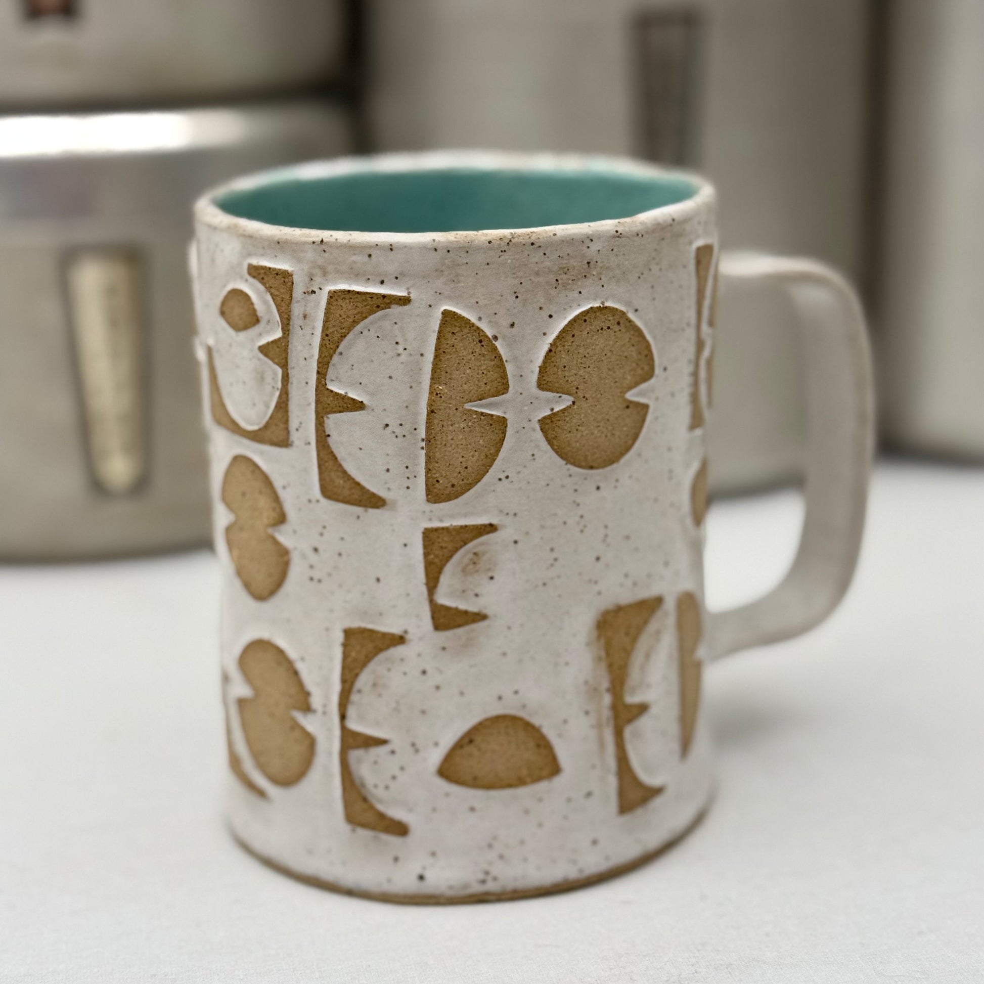 Ceramic mug with pattern on a white surface
