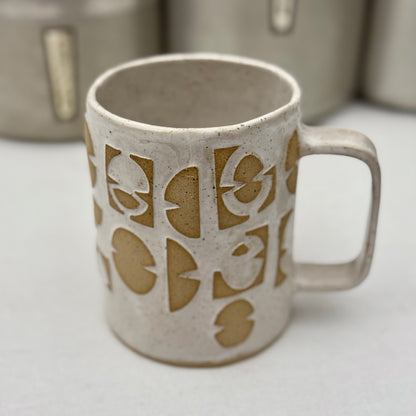 Ceramic mug with decorative patterns on a white surface