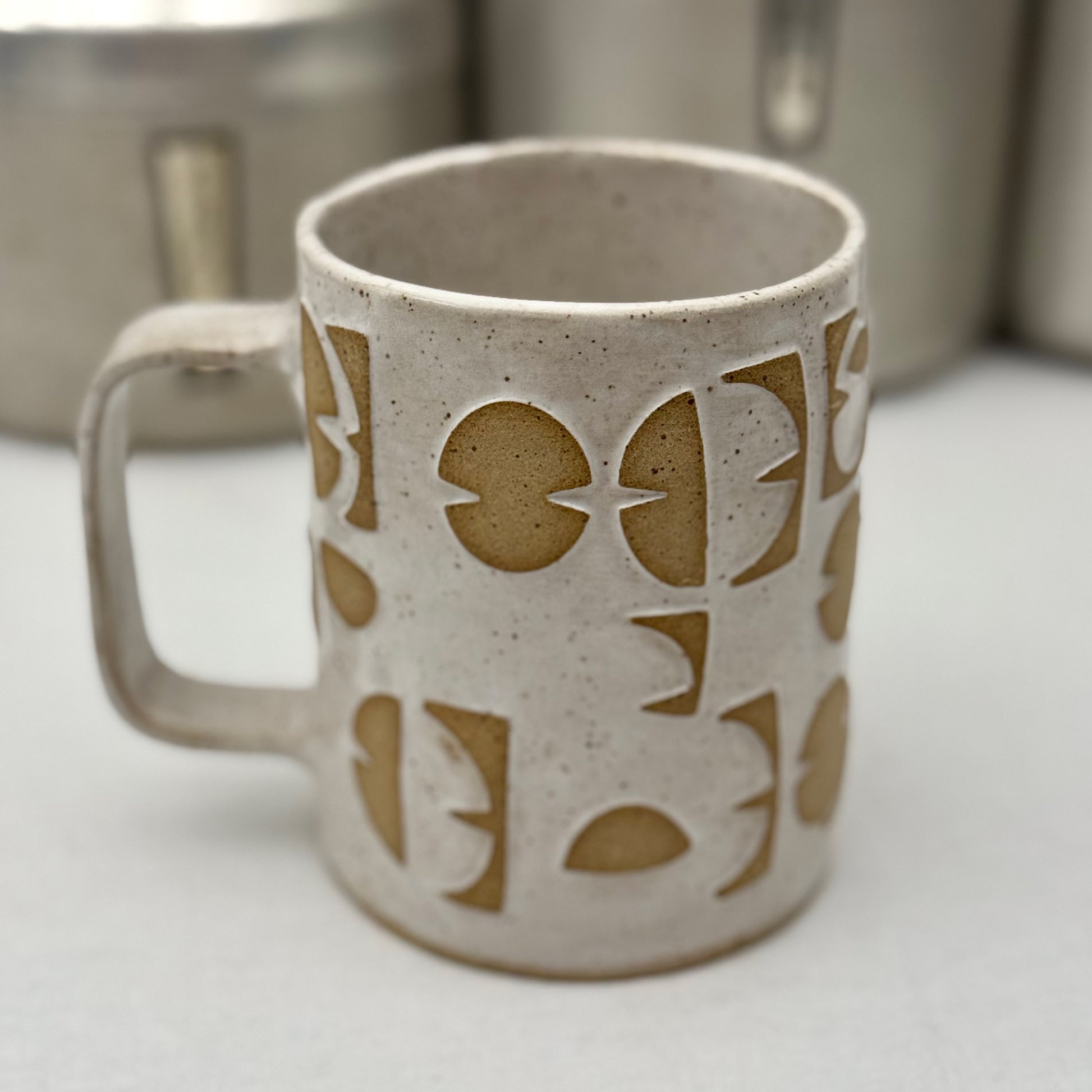 Ceramic mug with geometric design on a white surface