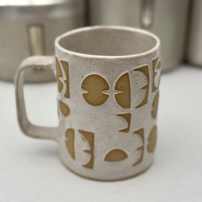 Ceramic mug with geometric design on a white surface
