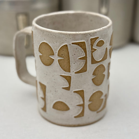 Ceramic mug with patterns on a white surface