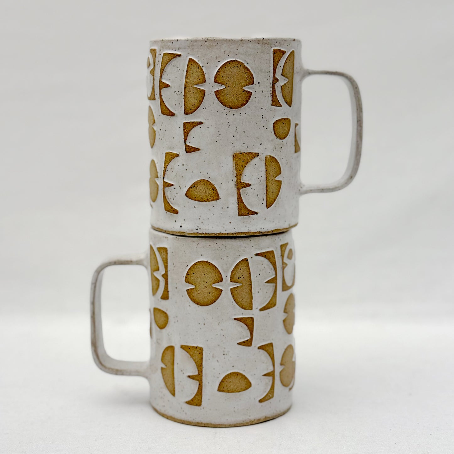 Ceramic mugs with geometric pattern on a white background