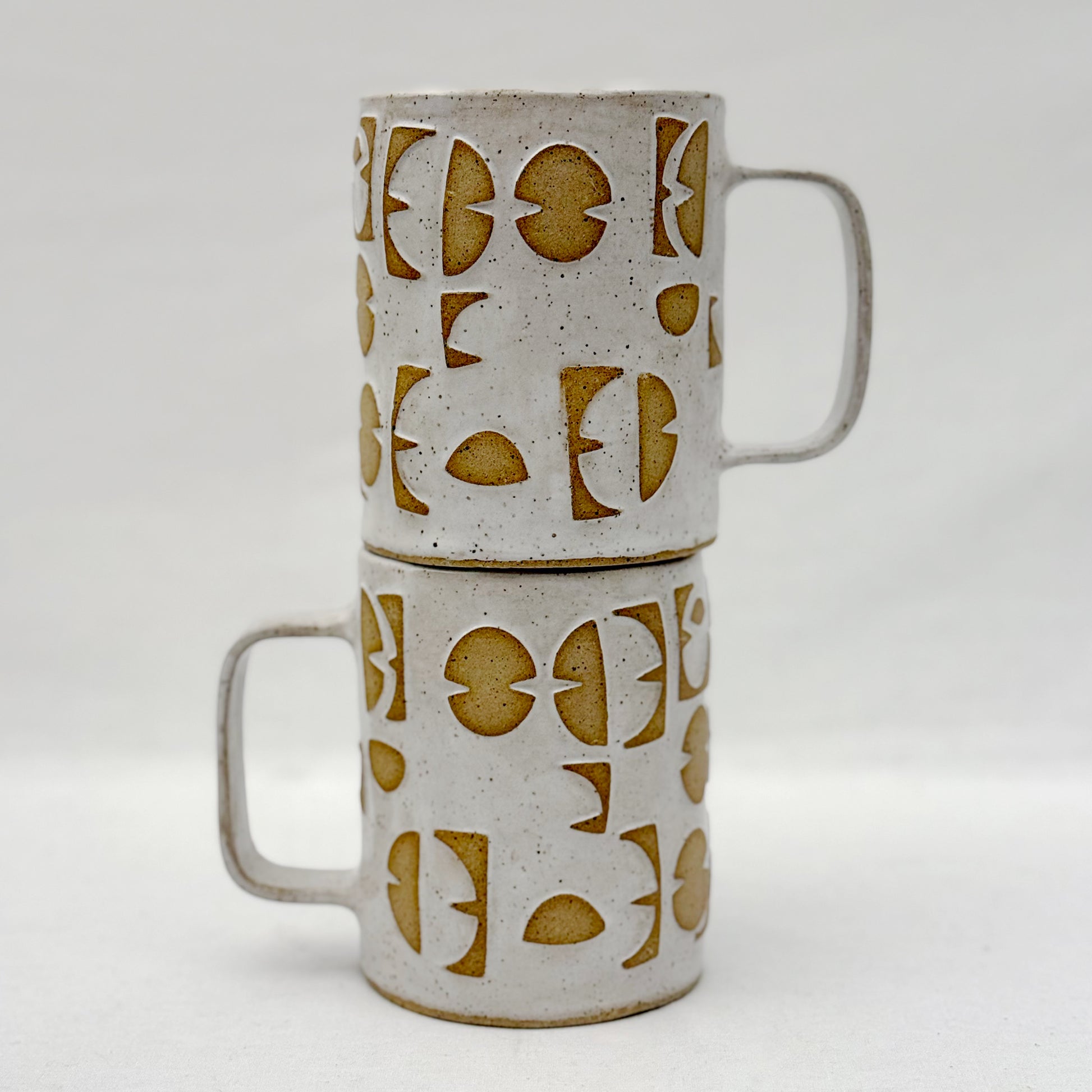 Ceramic mugs with geometric pattern on a white background