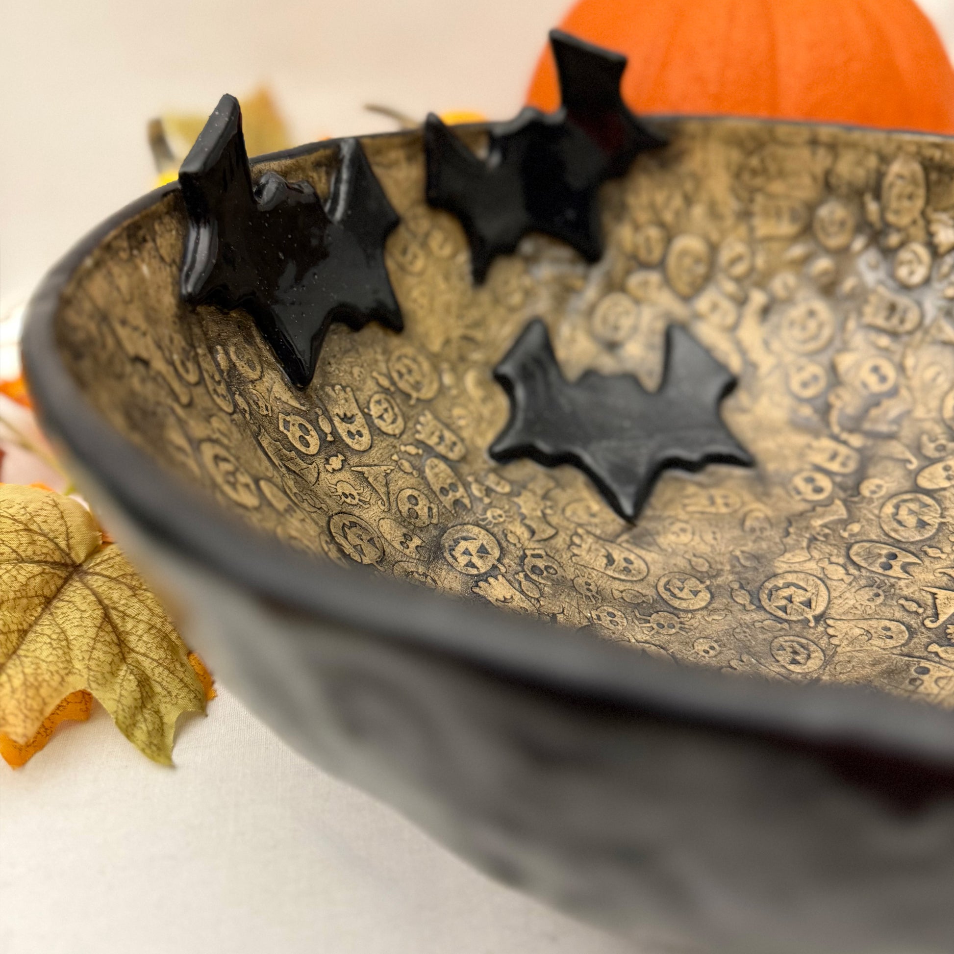 Ceramic candy bowl with halloween texture with bat accents.