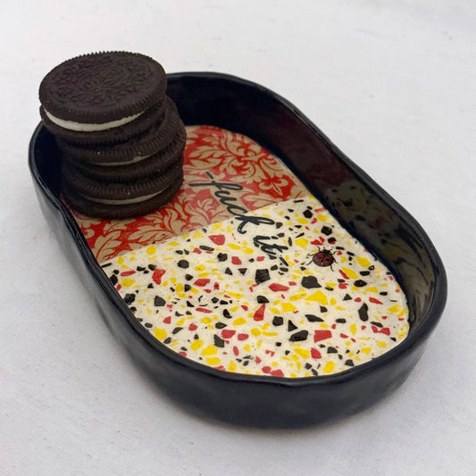 Ceramic damask and terrazzo-patterned tray with oreo cookies on a white background