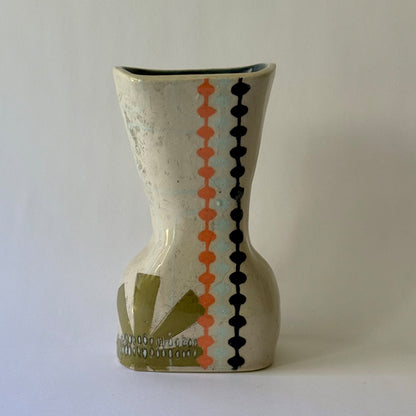 Handcrafted ceramic vase featuring mid-century inspired geometric patterns, floral motifs, and an hourglass shape.