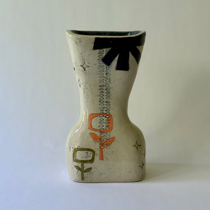 Handcrafted ceramic vase featuring mid-century inspired geometric patterns, floral motifs, and an hourglass shape.