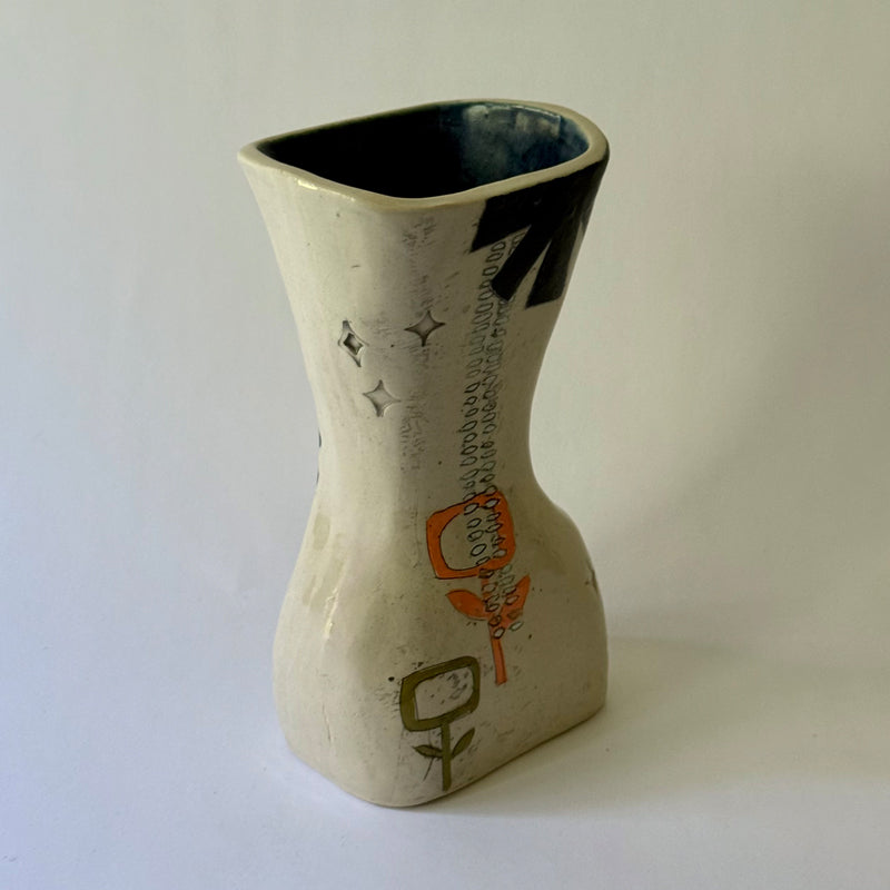 Handcrafted ceramic vase featuring mid-century inspired geometric patterns, floral motifs, and an hourglass shape.