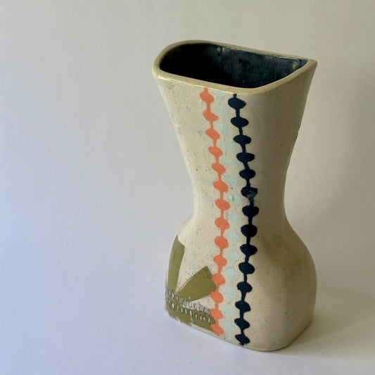 Handcrafted ceramic vase featuring mid-century inspired geometric patterns, floral motifs, and an hourglass shape.