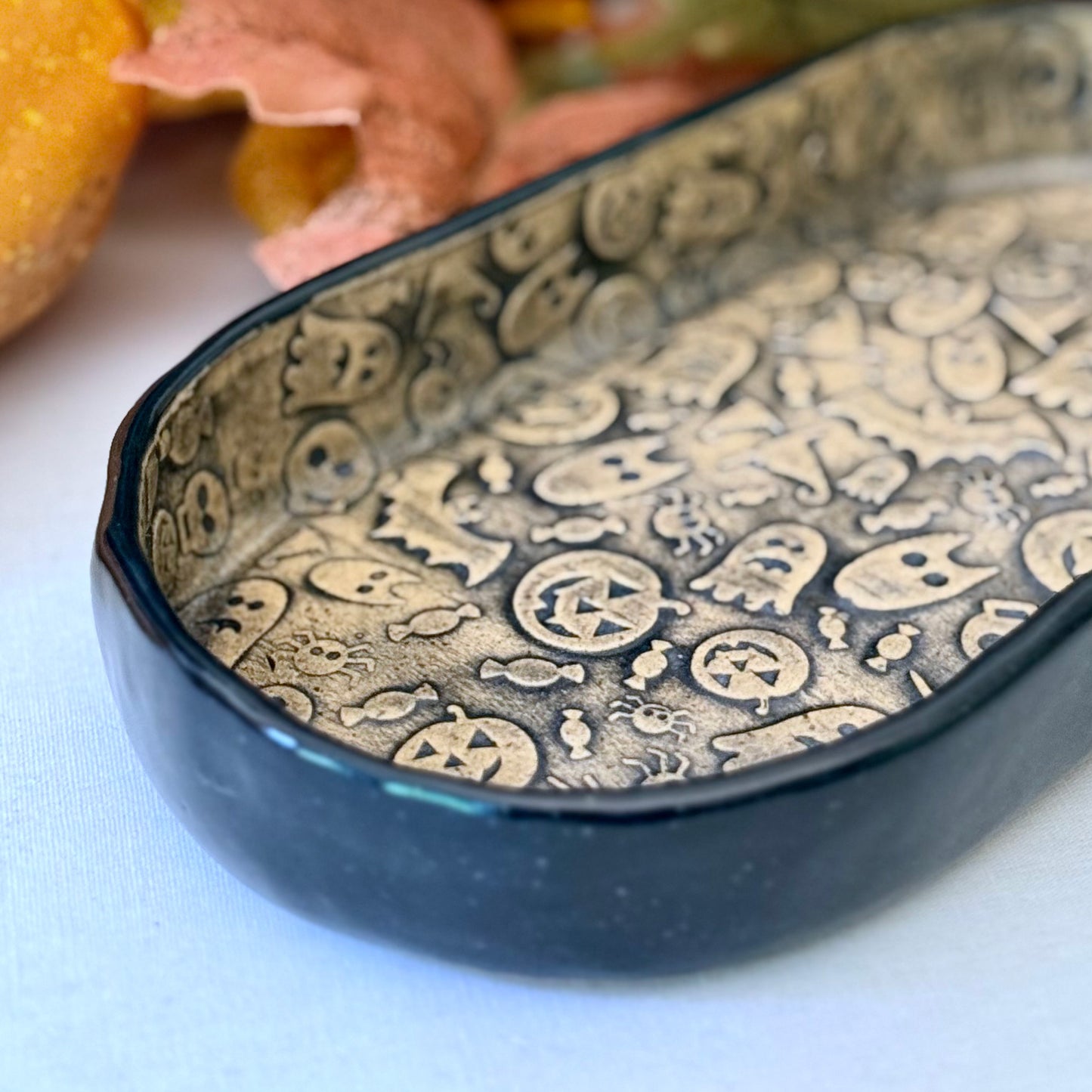 Ceramic dish with Halloween-themed pattern on a white surface
