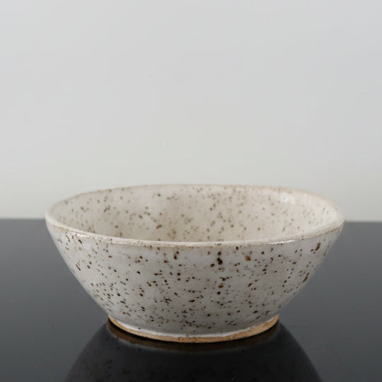 A handmade white speckled ceramic bowl 