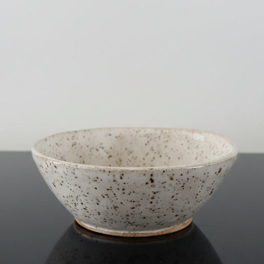 A handmade white speckled ceramic bowl 