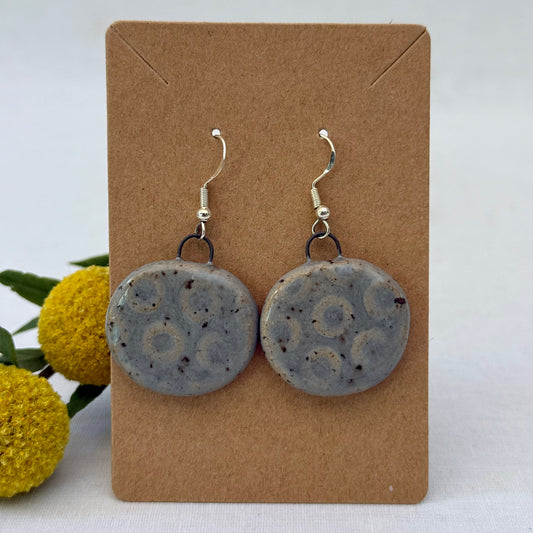 grey ceramic earrings on brown card