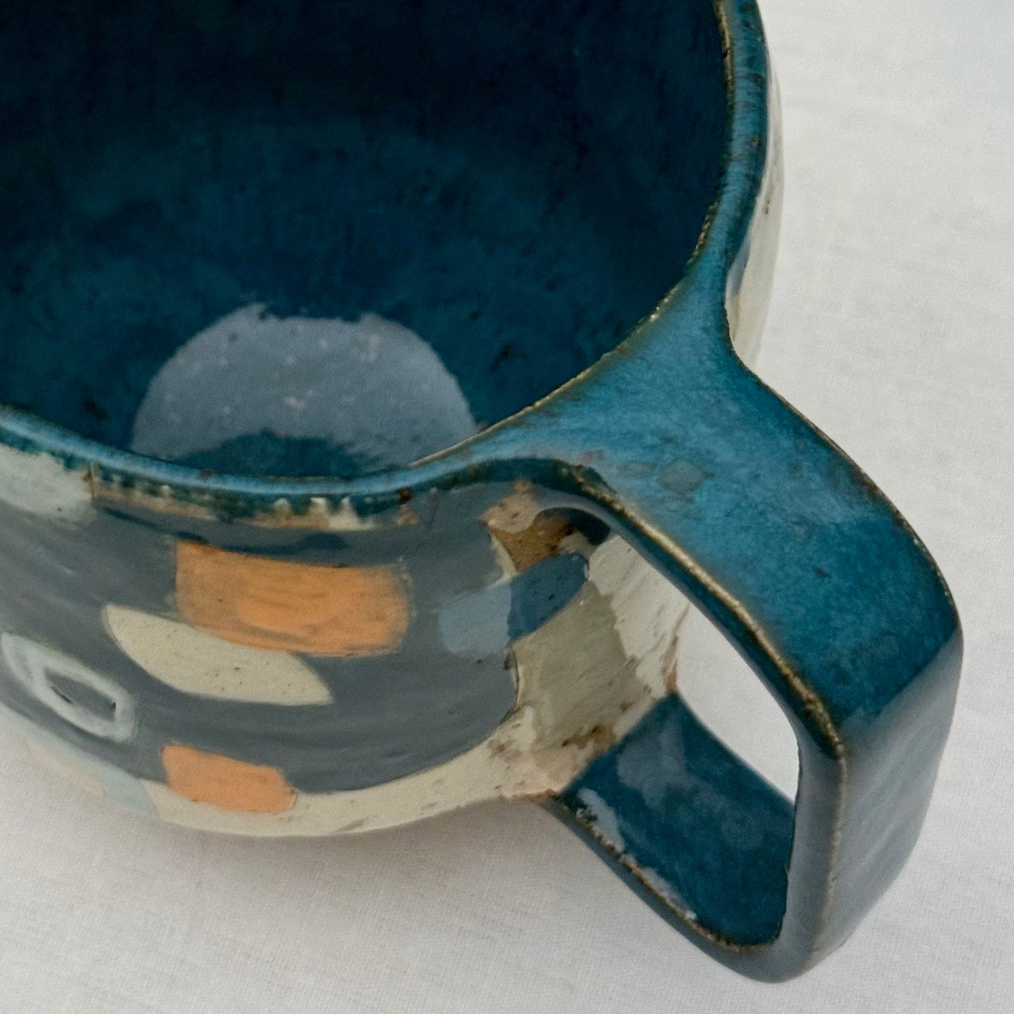 Ceramic mug with geometric pattern on a white surface