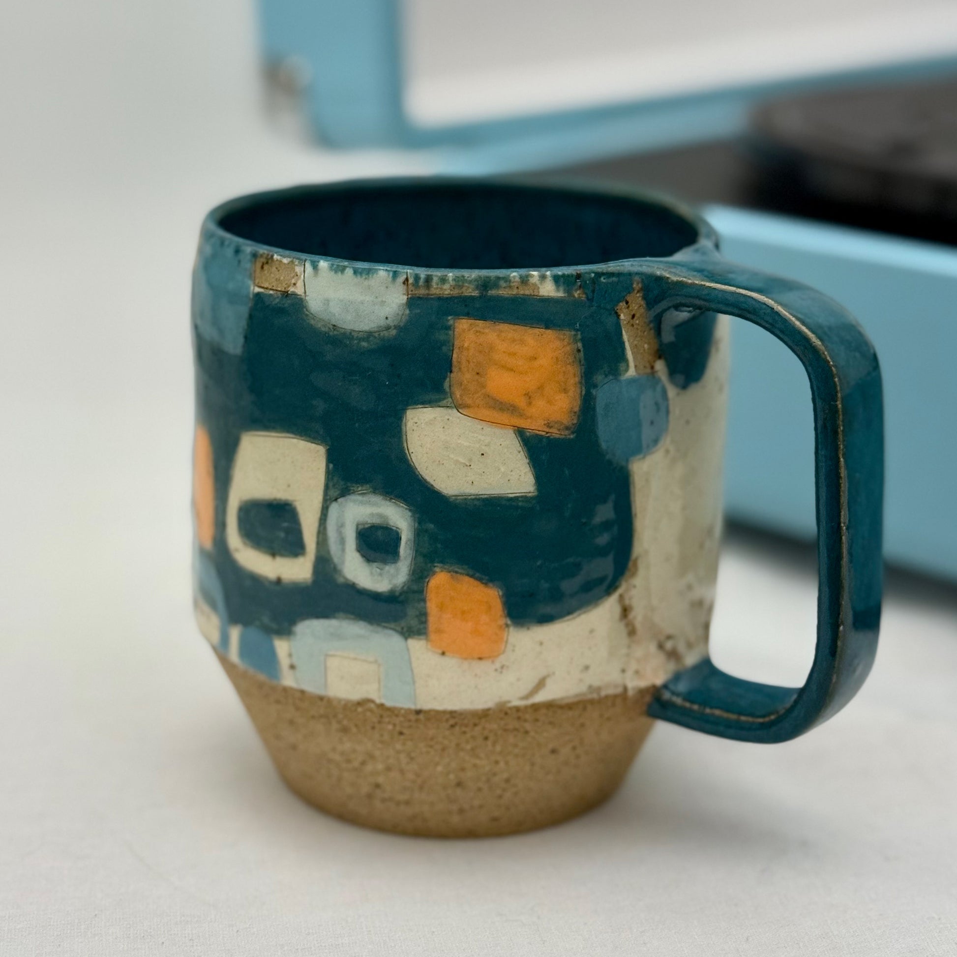 Ceramic mug with geometric pattern on a white surface