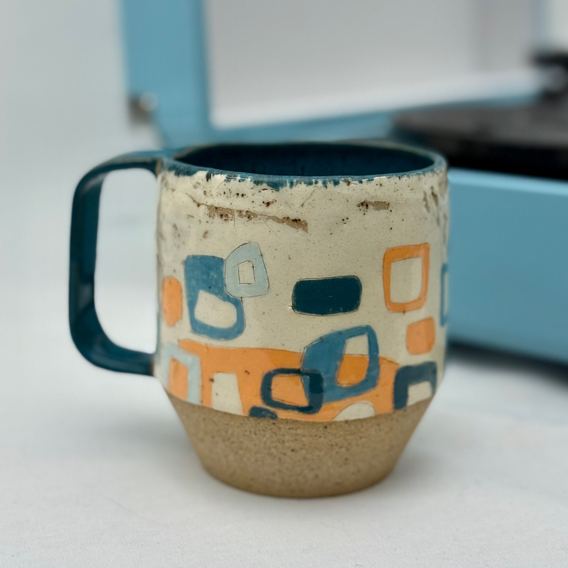Ceramic mug with geometric pattern on a white surface