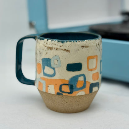 Ceramic mug with geometric pattern on a white surface