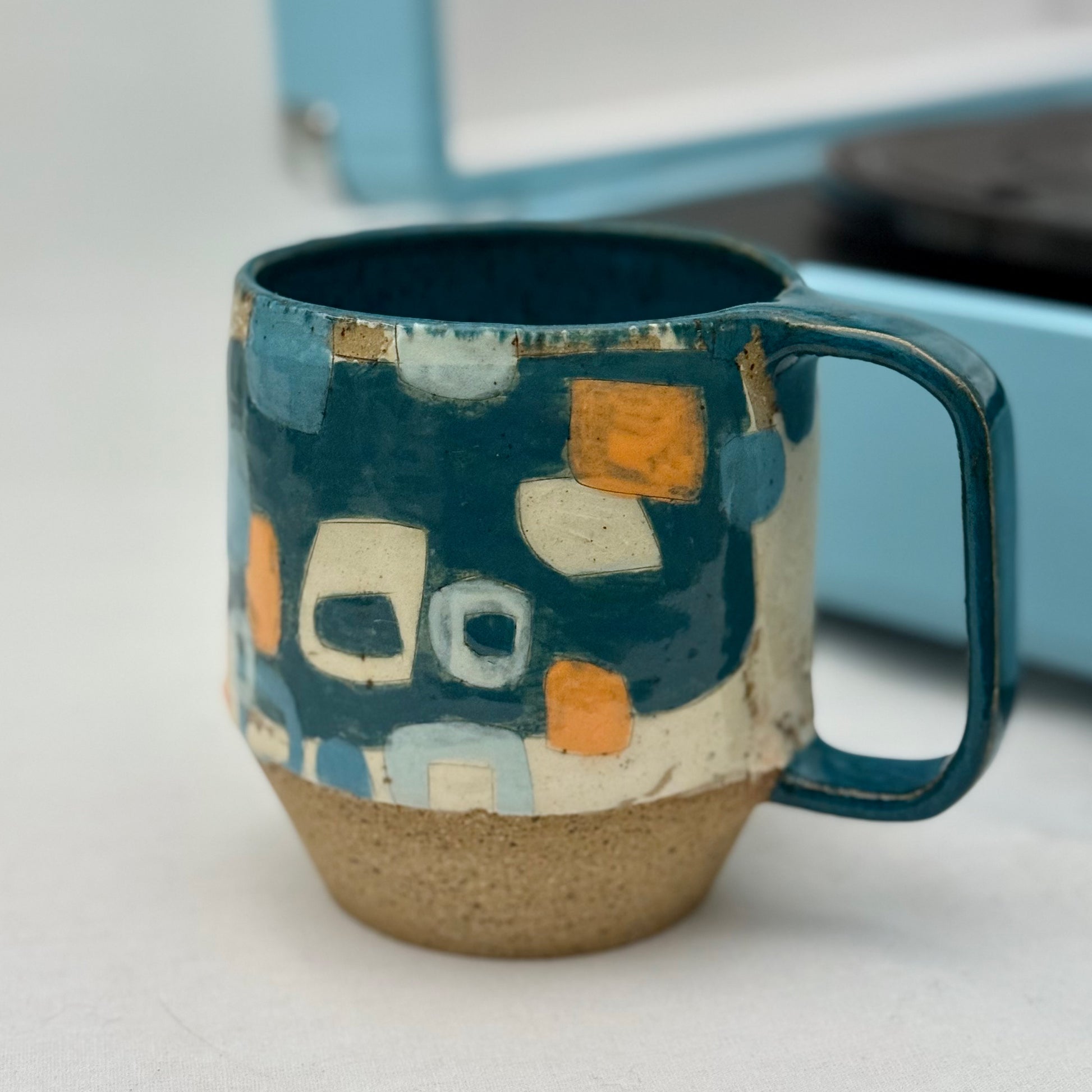 Ceramic mug with geometric pattern on a white surface