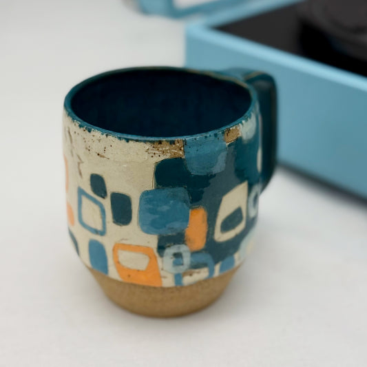 Ceramic mug with geometric pattern on a white surface