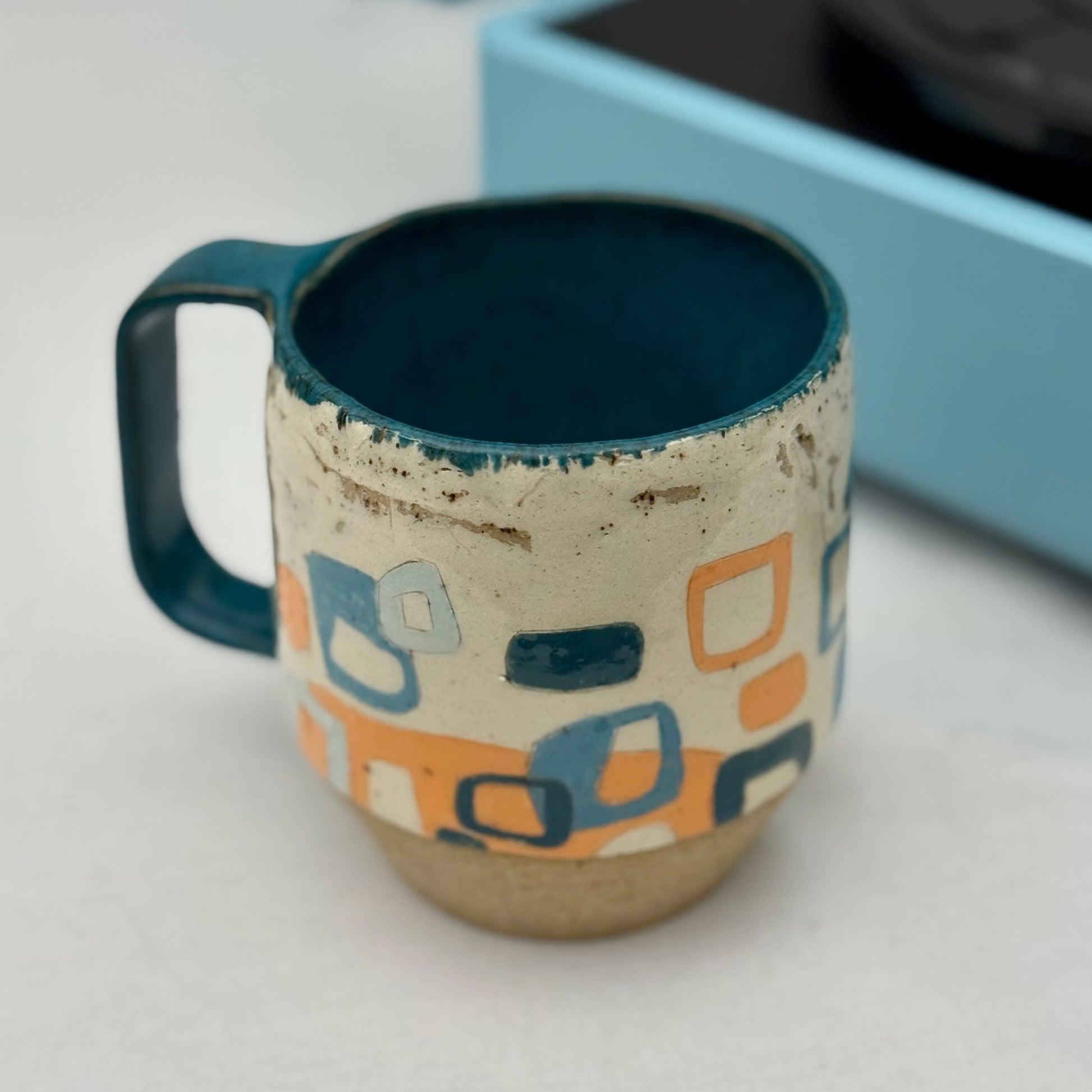 Ceramic mug with geometric pattern on a white surface