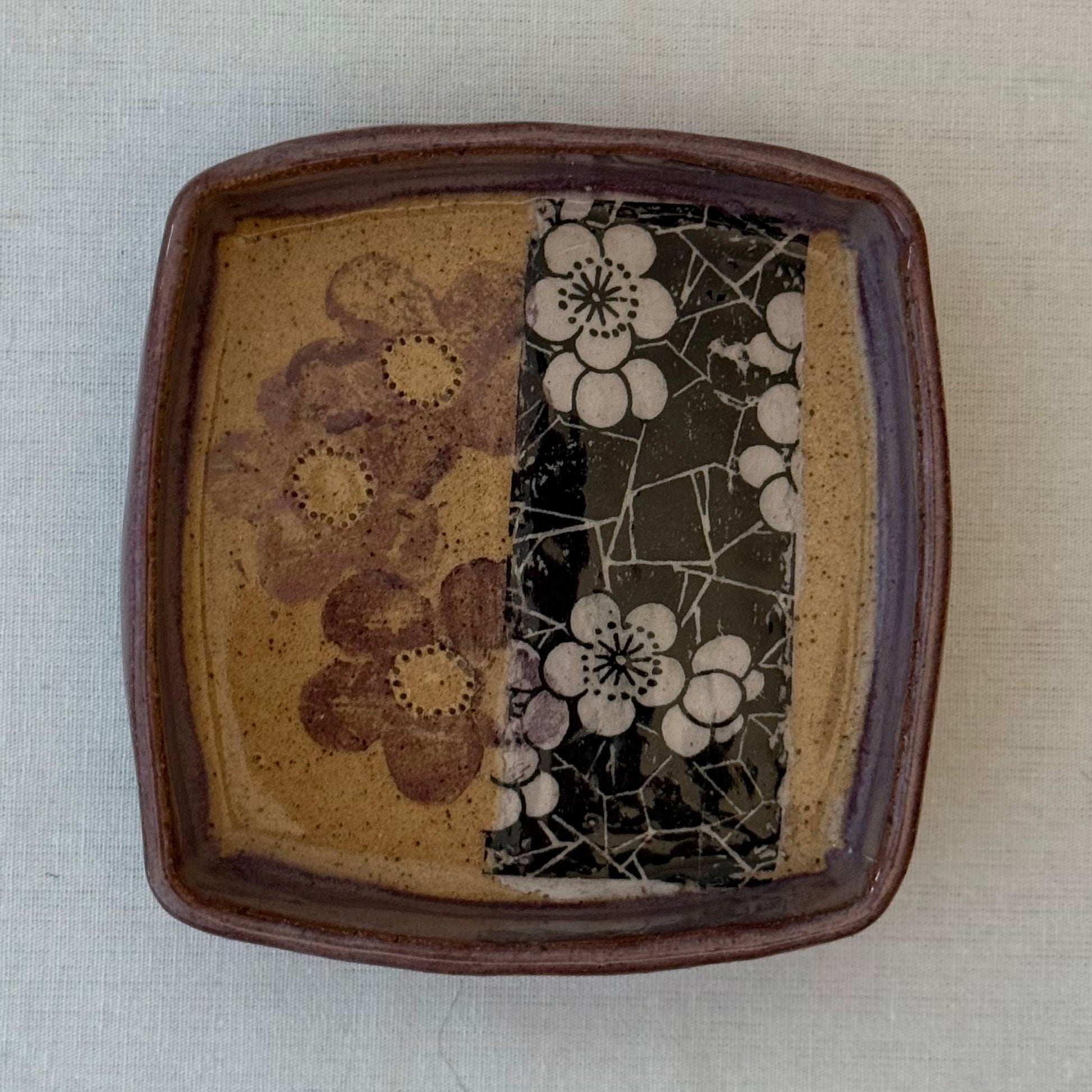 Ceramic tray with floral patterns on a white surface